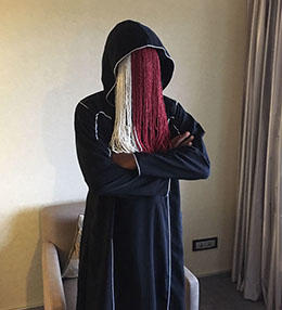 Investigative journalist Anas Aremeyaw Anas in Abuja, Nigeria, in June 2018, wearing beaded strands to obscure his face and hide his identity. (CPJ/Jonathan Rozen)