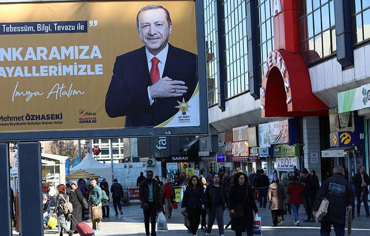 A campaign billboard for the ruling Justice and Development Party (AKP), pictured in Ankara on March 8. Police on March 19 detained a reporter and questioned her about her work in the capital. (AFP/Adem Altan)