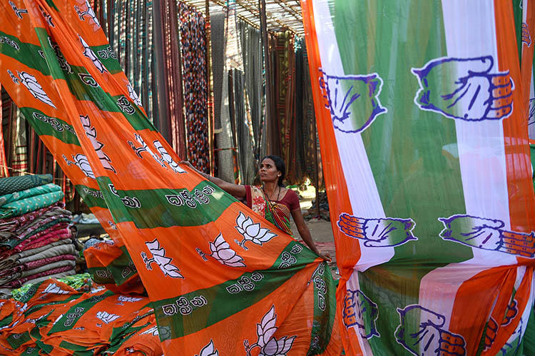 A worker dries material for the Bharatiya Janata Party (BJP) and Congress Party election campaigns on the outskirts of Ahmedabad, in March. India is due to hold elections from April 11 to May 19. (AFP/Sam Panthaky)