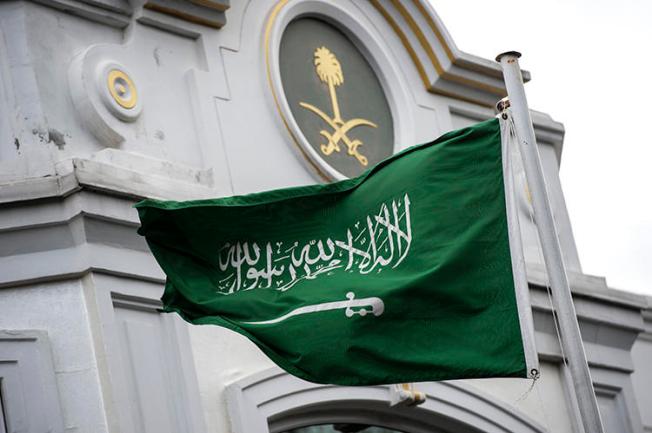 A Saudi flag flies in front of the country's consulate in Istanbul, where columnist Jamal Khashoggi was murdered, in October 2018. In Saudi Arabia, two female journalists who criticized the kingdom's driving ban are on trial. (AFP/Yasin Akgul)