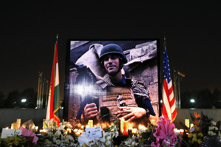 A photograph of James Foley, the freelance journalist killed by the IS group, is seen during a memorial service in Irbil, Iraq, on August 24, 2014. (Marko Drobnjakovic/AP)