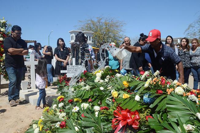 Flowers cover the casket of Santiago Barroso, a Mexican radio journalist shot dead in Sonora state in March. (Reuters/Cristian Torres)