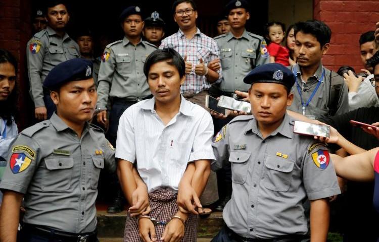 Detained Reuters journalists Kyaw Soe Oo and Wa Lone are escorted by police as they leave after a court hearing in Yangon, Myanmar, on August 20, 2018. The journalists will have their appeal heard at the Myanmar Supreme Court on March 26. (Ann Wang/Reuters)