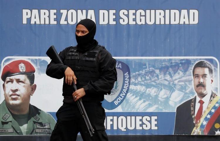 A member of the Bolivarian National Intelligence Service stands guard in Caracas, Venezuela, on May 16, 2018. Journalist Luis Carlos Díaz was recently detained by intelligence agents in Caracas. (Carlos Garcia Rawlins/Reuters)