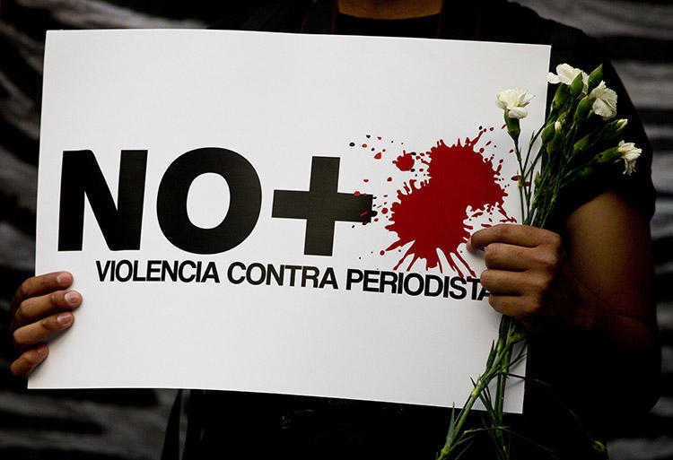 No more violence against journalists," reads a sign held by a protester during a demonstration outside the Interior Ministry in Mexico City on May 16, 2017. (AP/Rebecca Blackwell)