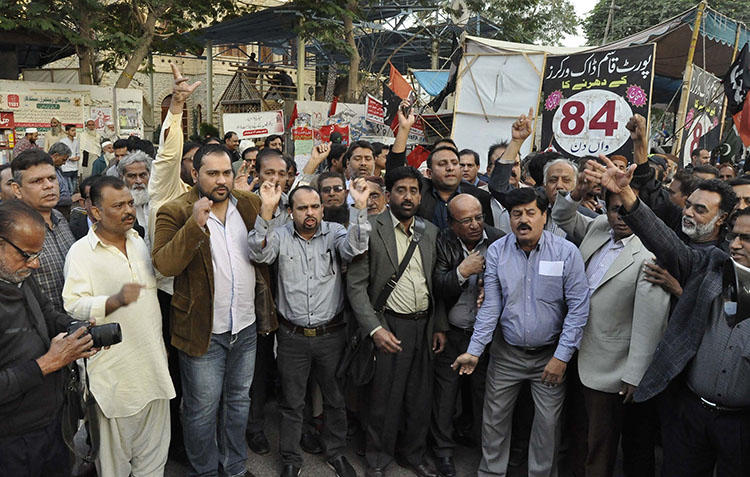 Pakistani journalists protest layoffs outside a press club in Karachi on December 17, 2018. Pakistan's military and security agencies exert pressure on local media, while the government slashes its advertising budget, squeezing a key source of revenue for private newspapers and TV stations. (AP/Fareed Khan)