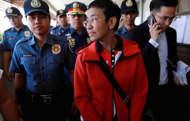 Rappler Founder and Executive Editor Maria Ressa is escorted by police after posting bail in Pasig Regional Trial Court in Pasig City, Philippines, on March 29, 2019. (Reuters/Eloisa Lopez)