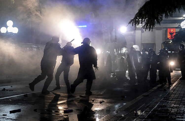 Police officers arrest a protester in Tirana, Albania, on April 13, 2019. Several journalists were injured during the demonstrations. (AFP/Gent Shkullaku)