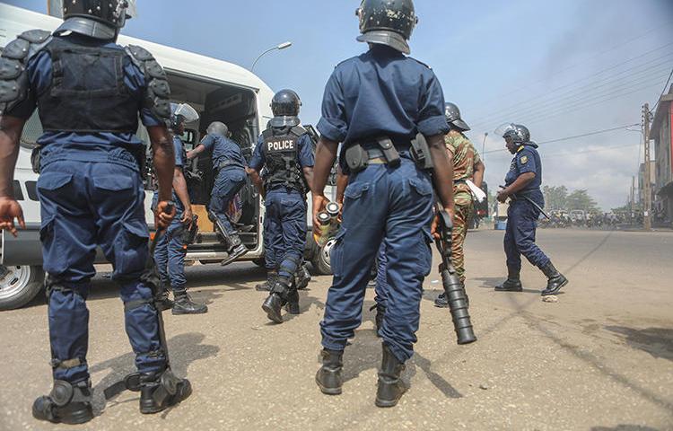 Police officers are seen in Cotonou, Benin, on March 9, 2018. Beninese authorities recently launched a fake news investigation into Casimir Kpedjo, editor of the privately owned daily Nouvelle Economie. (AFP/Yanick Folly)