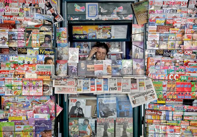 A newspaper vendor is seen in Bucharest, Romania, on May 30, 2017. Romanian reporter Emilia Șercan recently received death threats relating to her work. (AP/Vadim Ghirda)