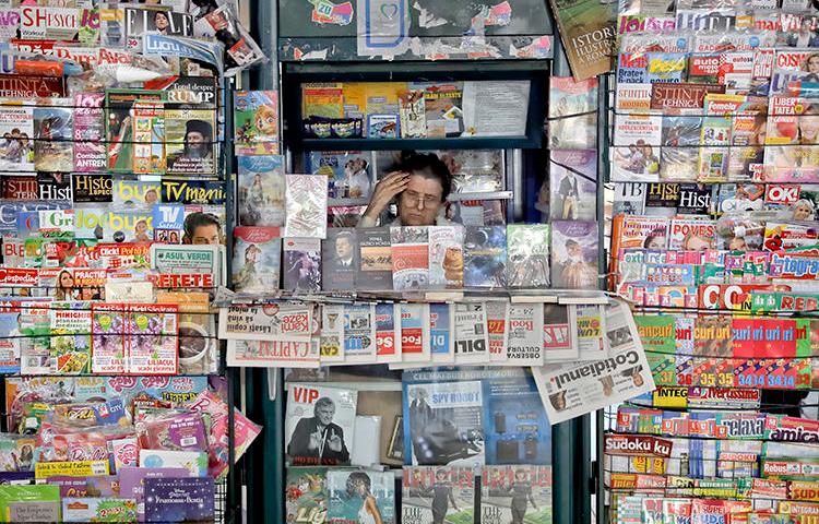 A newspaper vendor is seen in Bucharest, Romania, on May 30, 2017. Romanian reporter Emilia Șercan recently received death threats relating to her work. (AP/Vadim Ghirda)