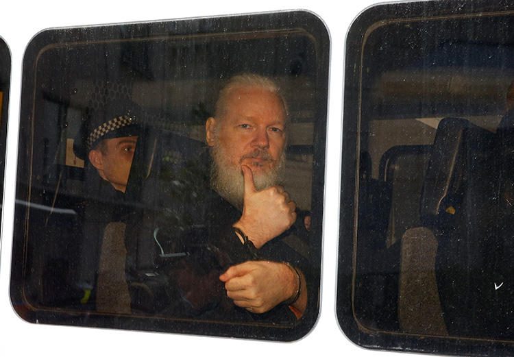 WikiLeaks founder Julian Assange is seen in a police van after he was arrested in London on April 11, 2019. (Reuters/Henry Nicholls)