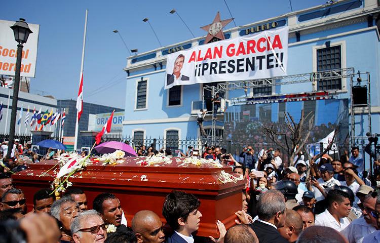 Friends and family carry the coffin of Peru's former president, Alan Garcia, who killed himself on April 17, in Lima, Peru, on April 19, 2019. Some government officials have blamed Peruvian investigative journalists for his suicide, and engaged in a harassment campaign. (Reuters/Janine Costa)