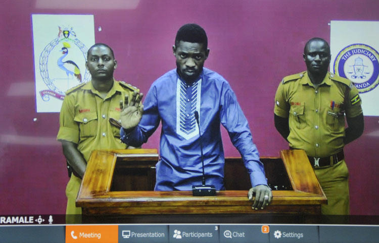 Ugandan pop star and opposition figure Bobi Wine appears for his bail application via a video link from prison, on a television screen in a court in Kampala, Uganda, on May 2, 2019. Uganda's media regulator suspended staff from 13 broadcast outlets for covering his arrest. (AP/Ronald Kabuubi)