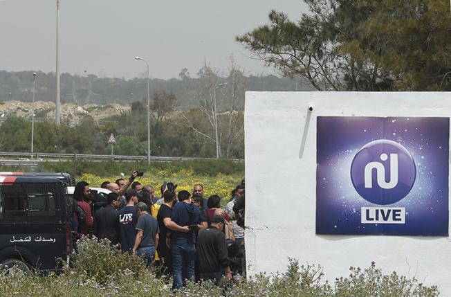 Security forces are seen closing down the private Nessma TV broadcaster on April 25, 2019, in Rades, Tunisia. (AFP/Fethi Belaid)