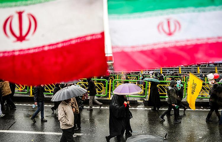 People carry umbrellas in Tehran, Iran, on February 11, 2019. On May 1, two journalists were arrested while covering Labor Day demonstrations in Tehran. (Vahid Ahmadi/Tasnim News Agency via Reuters)