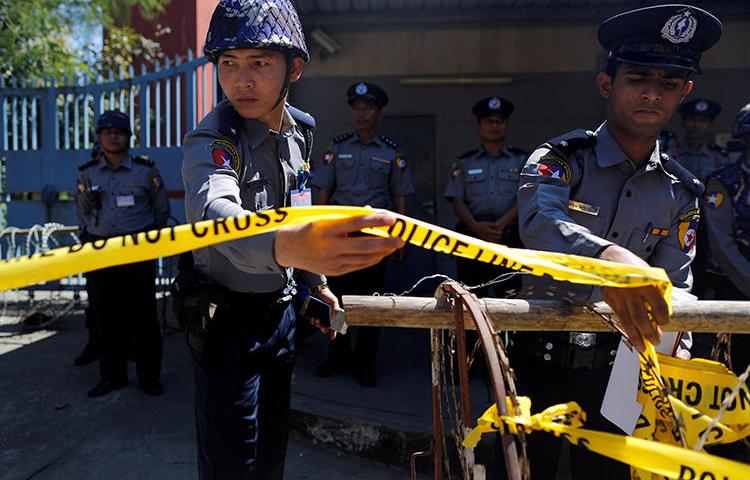 Polices are seen in Yangon, Myanmar, on February 24, 2017. Journalist Aung Marm Oo went into hiding earlier this month as police seek his arrest. (Reuters/Soe Zeya Tun)