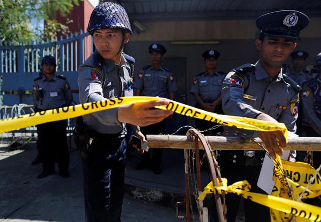 Polices are seen in Yangon, Myanmar, on February 24, 2017. Journalist Aung Marm Oo went into hiding earlier this month as police seek his arrest. (Reuters/Soe Zeya Tun)