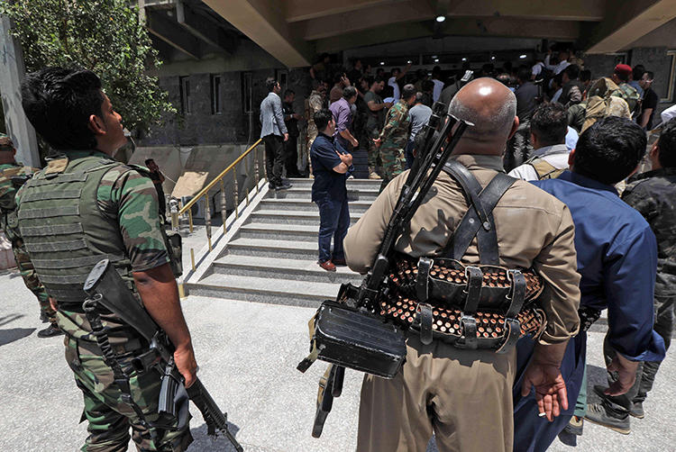 Kurdish security forces are seen in Erbil, Iraqi Kurdistan, on July 23, 2018. Security forces recently harassed and attempted to arrest journalist Barzan Ali Hama. (AFP/Safin Hamed)