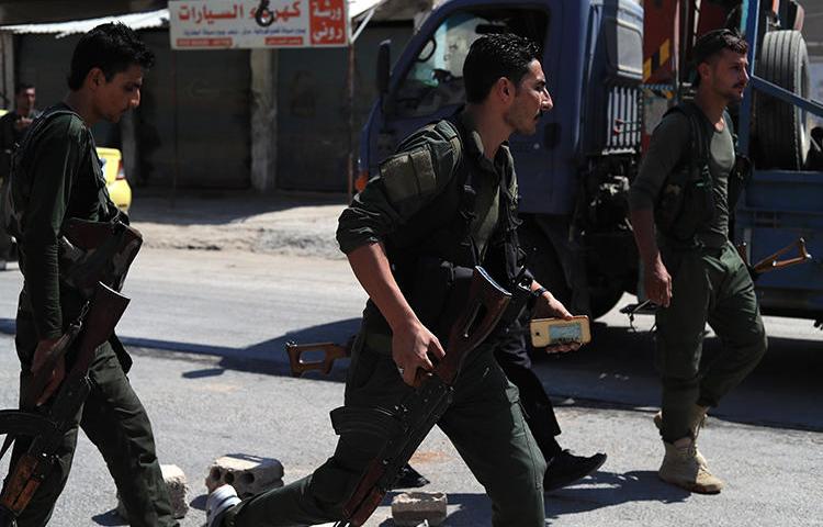 Members of the Asayish are seen in Qamishli, northeastern Syria, on September 8, 2018. Asayish forces recently detained journalist Mohammad Tawfiq al-Saghir near Qamishli. (AFP/Delil Souleiman)