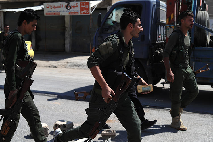 Members of the Asayish are seen in Qamishli, northeastern Syria, on September 8, 2018. Asayish forces recently detained journalist Mohammad Tawfiq al-Saghir near Qamishli. (AFP/Delil Souleiman)