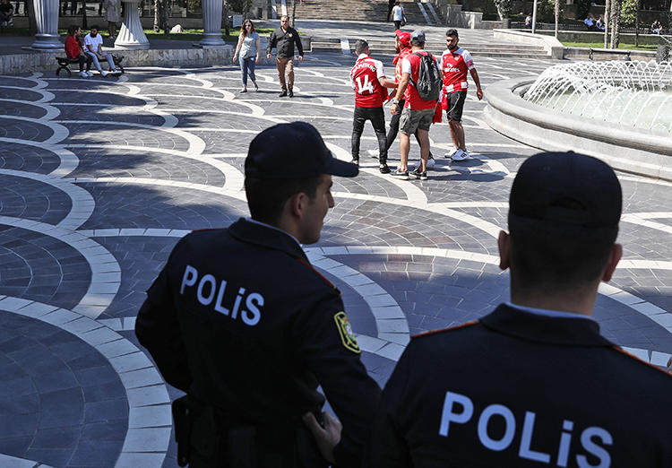 Police officers are seen in Baku, Azerbaijan, on May 29, 2019. Azerbaijani authorities recently jailed two journalists in unrelated cases. (AP/Darko Bandic)