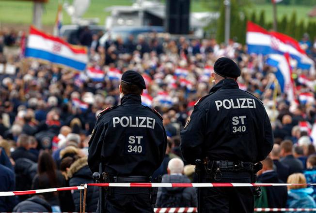 Austrian police, pictured at a World War II memorial in Bleiburg on May 18, 2019, that was attended by thousands of Croatian far-right supporters. A Croatian journalist says he was harassed and assaulted during the event. (AP/Darko Bandic)