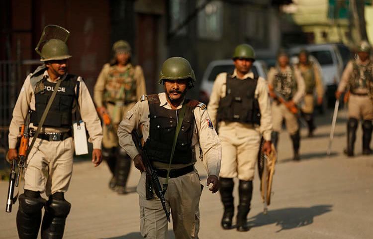 Police are seen in Srinagar, Indian-controlled Jammu and Kashmir, on May 21, 2019. Police in Jammu and Kashmir recently arrested journalist Ghulam Jeelani Qadri. (AP/Mukhtar Khan)