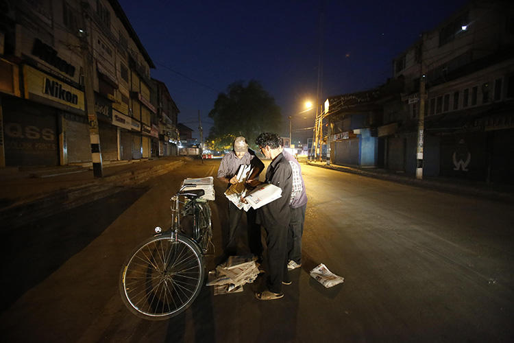 Newspaper vendors collect copies of the papers in Srinagar, in July 2016. The Kashmir Times, one of the oldest papers in Indian-controlled Jammu and Kashmir, is suffering under a nearly 10-year ban on government advertising. (AP/Mukhtar Khan)