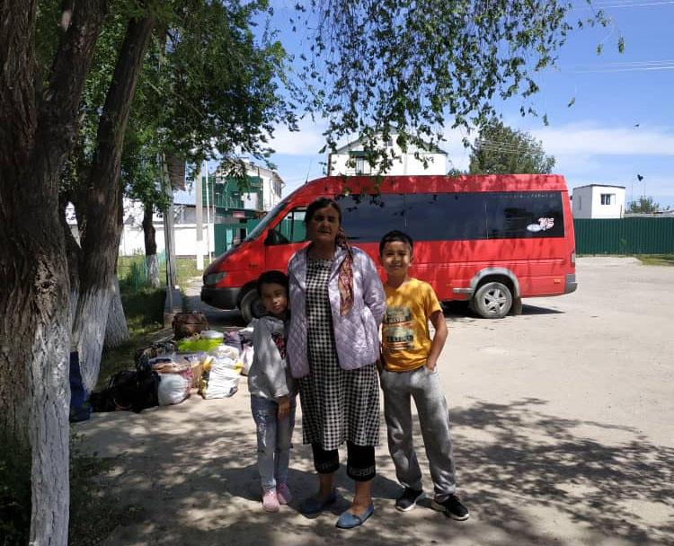 Khadicha Askarova, pictured with her grandchildren in May 2019, as the family travels over 600km to see Azimjon Askarov in prison on his birthday. (Askarov family)