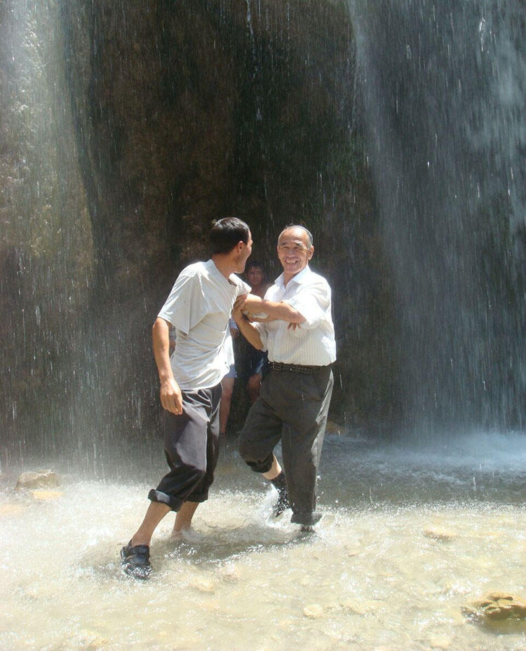 Azimjon Askarov and his son, pictured during a family vacation in 2009. Askarov's wife says the journalist used to be full of energy but his long imprisonment has left him sickly. (Askarov family)