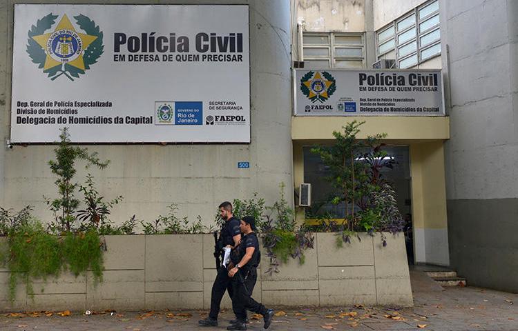 Police officers walk in front of the homicide department in Rio de Janeiro, Brazil, on March 13, 2019. Journalist Romário Barros was recently killed in Maricá, in Rio de Janeiro state. (Reuters/Lucas Landau)