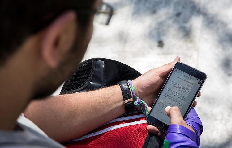 A man uses his smartphone to follow election news in Tehran, Iran, May 17, 2017. Iran charged four Telegram news channel Gam reporters over labor coverage, it was reported June 11. (Reuters/TIMA)