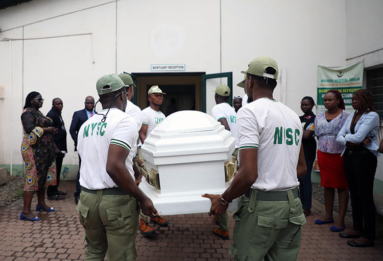 Members of National Youth Service Corp carry the body of their colleague, the reporter Precious Owolabi, in Abuja on July 23. Owolabi was shot while covering protests in the Nigeria capital. (AFP/Kola Sulaimon)