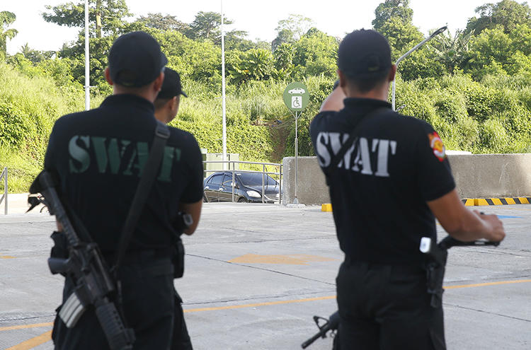 Philippine National Police SWAT members are seen in Tanauan City on July 4, 2018. Radio broadcaster Eduardo Dizon was recently killed in Kidapawan City, in the southern Philippines. (AP/Bullit Marquez)