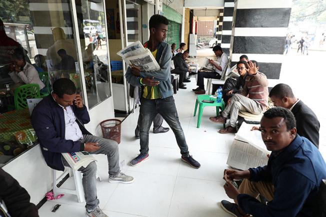 Ethiopians read newspapers in Addis Ababa on June 24. Following what the government refers to as a failed attempted coup, access to the internet was cut and journalists were arrested. (Reuters/Tiksa Negeri)