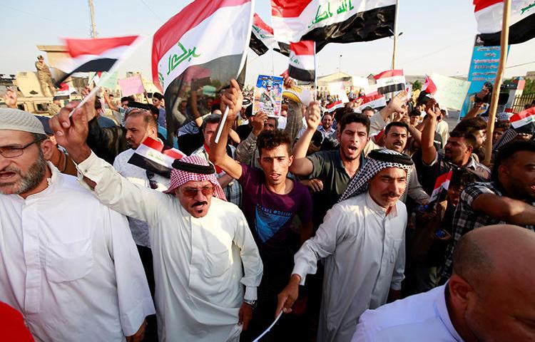 Demonstrators are seen in Basra, Iraq, on July 19, 2019. During the protest, demonstrators assaulted journalist Ayman al-Sheikh. (Reuters/Alaa Al-Marjani)