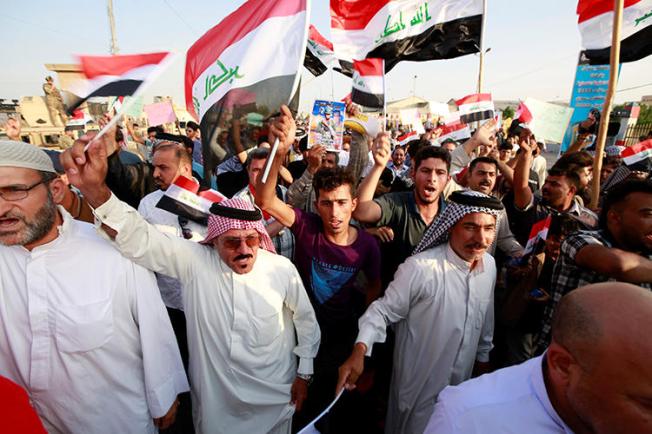 Demonstrators are seen in Basra, Iraq, on July 19, 2019. During the protest, demonstrators assaulted journalist Ayman al-Sheikh. (Reuters/Alaa Al-Marjani)