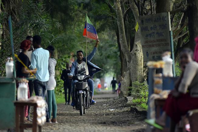 A man rides a motorcycle as young people of the Sidama ethnic group, the largest in southern Ethiopia, celebrate at Hawassa city over plans by local elders to declare the establishment of a breakaway region for the Sidama, in Awasa, July 15, 2019. Authorities arrested three media workers from the Sidama Media Network on July 18. (AFP/Michael Tewelde)