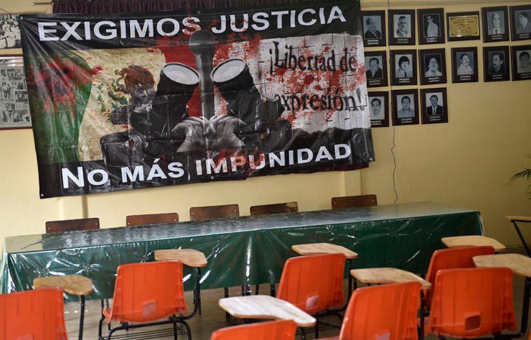 A sign reading 'We demand justice. No more impunity' hangs at the journalists' union office in Chilpancingo, Guerrero state, in May 2017. Two journalists from the state were killed within days of each other this week. (AFP/Pedro Pardo)