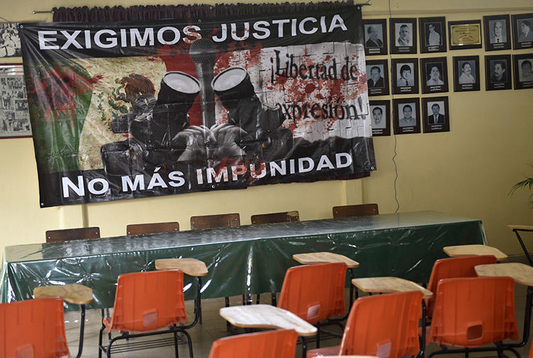 A sign reading 'We demand justice. No more impunity' hangs at the journalists' union office in Chilpancingo, Guerrero state, in May 2017. Two journalists from the state were killed within days of each other this week. (AFP/Pedro Pardo)