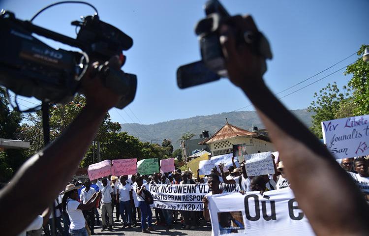 Haitian reporters and others protest in Port-au-Prince on March 28, 2018, calling for information on missing photojournalist Vladimir Legagneur. Another journalist, Luckson Saint-Vil, was shot at in southern Haiti on August 6, 2019. (AFP/Hector Retamal)