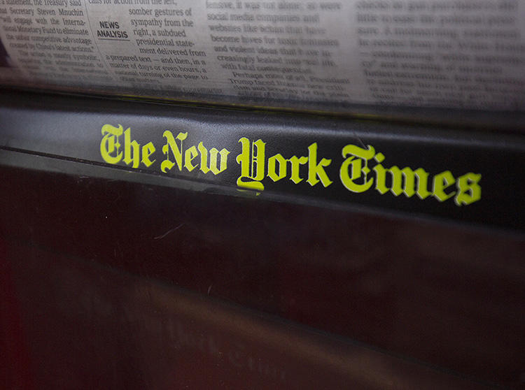 The New York Times logo is seen on a newspaper rack at a convenience store in Washington, D.C., on August 6, 2019. CPJ and RCFP filed a lawsuit on August 8 seeking documents in a leak investigation involving a Times reporter. (AFP/Alastair Pike)