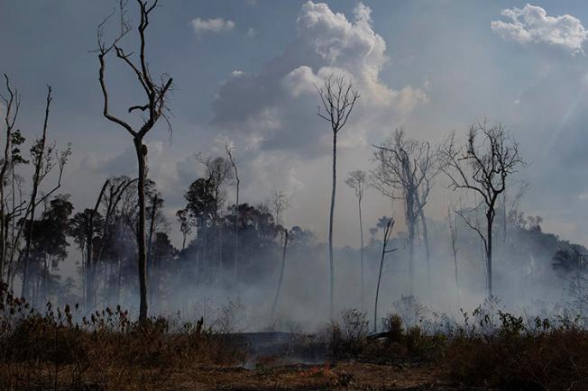 An area smolders in the Alvorada da Amazonia region in Novo Progresso, Para state, Brazil, on August 25, 2019. Brazilian journalist Adecio Piran was threatened on August 28 after reporting on fires in the region. (AP Photo/Leo Correa)