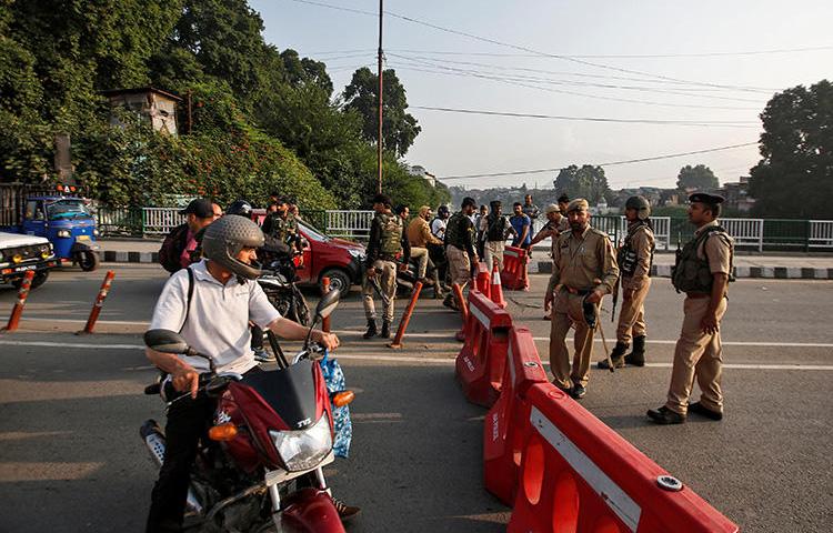 Indian security personnel stop people during restrictions in Srinagar, in Indian-controlled Jammu and Kashmir state, on August 5, 2019. Indian authorities that day blocked the internet and communications networks in the region. (Reuters/Danish Ismail)