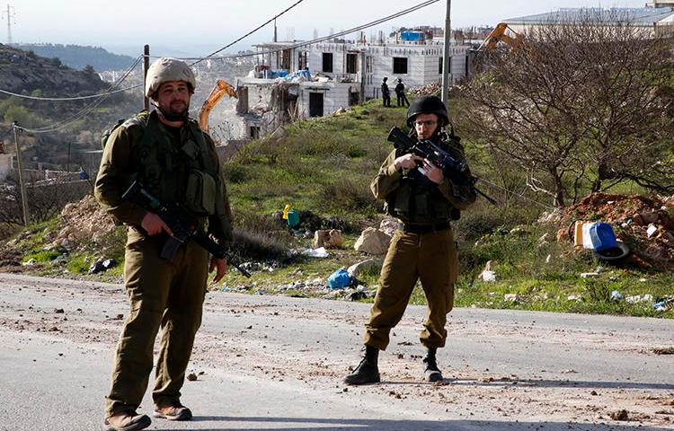 Israeli security forces are seen in the West Bank on February 14, 2018. Palestinian journalist Abdul Mohsen Shalaldeh was recently arrested in the West Bank and is being held without charge. (AFP/Hazem Bader)