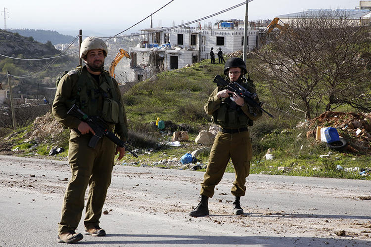 Israeli security forces are seen in the West Bank on February 14, 2018. Palestinian journalist Abdul Mohsen Shalaldeh was recently arrested in the West Bank and is being held without charge. (AFP/Hazem Bader)