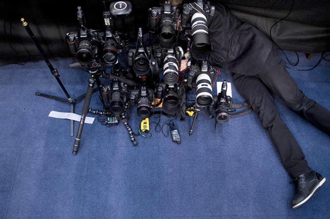 A photographer sets a remote camera before Facebook CEO Mark Zuckerberg's appearance at a joint hearing on Capitol Hill in April 2018. Online harassment is perceived as the biggest threat for journalists in the U.S. and Canada, CPJ's safety survey found. (AFP/Brendan Smialowski)