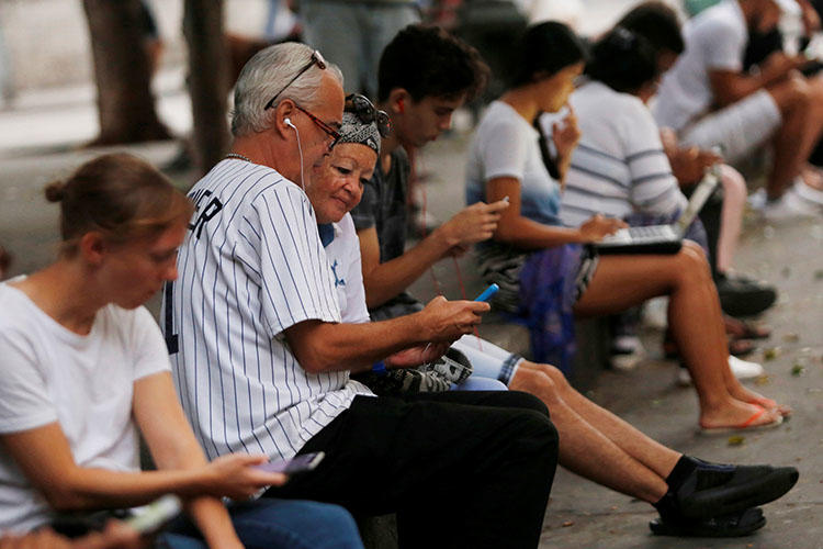 People use the internet at a hotspot in Havana, Cuba in December 2018. Journalists and bloggers say recent internet regulations could legitimize censorship. (REUTERS/Stringer)