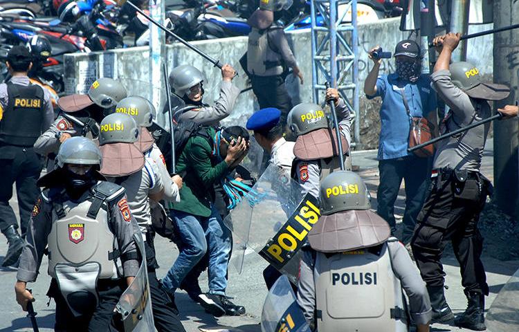 Police beat students in Makassar, Indonesia, on September 24, 2019. Several journalists were injured by police while covering the student protests. (Antara Foto/Abriawan Abhe via Reuters)